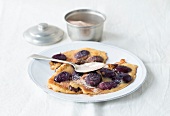 Pancakes with plums on plate