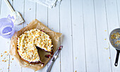 Cherry and banana pie with almonds flakes on baking paper