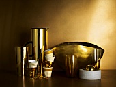 Golden dishes, coffee mugs, shakers and thermos