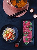 Chinese fondue, beef and a glass noodle salad