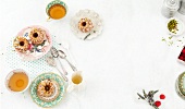 Mini bundt cakes on plates with tea cups on white background