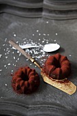Mini coconut ice cup Bundt cakes with chocolate and cocoa powder