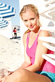 Blonde, sporty woman with a ponytail on the beach