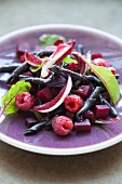 A salad with black ciocchetti, beetroot, radicchio and raspberries