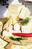 Various types of cheese on a wooden board