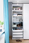 An organiser system with drawers, shoe boxes and a divider drawer in a bedroom