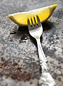 A lemon wedge on a fork