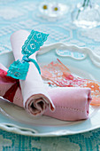 Napkins tied with lace ribbons