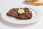 Fried steaks with herb butter
