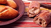 Ciabatta next to a breadbasket with a bread roll