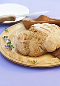 Three grain bread on a wooden plate