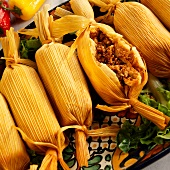 Serving Platter of Meat Filled Tamales; One Cut Open
