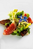 A salad with figs and flowers