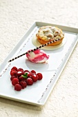 A raspberry tartlet with raspberry ice cream and fresh raspberries