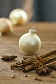 A Christmas arrangement with star anise, cinnamon sticks and Christmas tree baubles