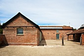 English grange with brick facade and barren courtyard