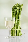A bunch of asparagus and a glass of white wine
