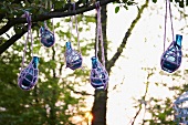 Colored bottles in nets as garden decoration