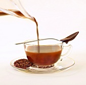 Cocoa Infused Tea; Chocolate Infused Rooibos Tea with Loose Tea Leaves on Saucer; Chocolate Spoon