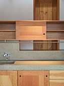Custom made kitchen cupboards made of solid wood and work surface with integrated stone sink