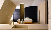 Waschtisch aus Stein im Schlafraum mit Bett vor schwarzer holzvertäfelter Wand
