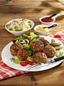 Meatballs with potato salad, mustard and ketchup