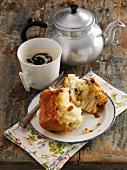A baked, sweet yeast dumpling and coffee