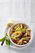 Penne pasta with dried tomatoes and spring onions