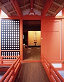 Traditional, Japanese home with bright red lacquered door and view of floor mats