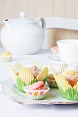 Muffins in tulip-shaped paper cases with macaroons