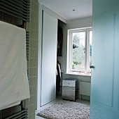 A heated towel rail next to a door in a changing room