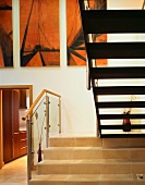 A stairway with stone step and the underside of a flight of stairs in an anteroom