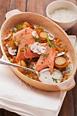 Brook trout with vegetables in a creamy white wine sauce