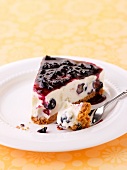 A slice of a blueberry cream cheese cake on a plate