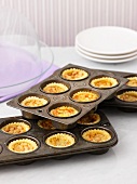 Mini butter tarts in a baking tin