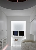 White guest room with flokati blanket on bed and transparent Plexiglas chair in front of window