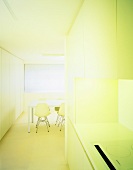 White fitted kitchen in niche of open-plan dining room