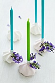 Candles in meringue candleholders decorated with lavender flowers