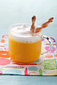 Carrot and orange soup with milk foam