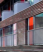 Modern house facade with balcony and horizontal wooden slat cladding