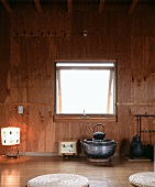 Simple Japanese tea room with wood-clad wall