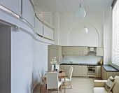 Dining area in modern open-plan kitchen with view of gallery and classic ambience