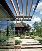Sun screen porch of wooden slats on modern glass facade
