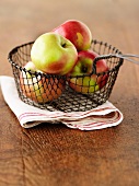 Fresh apples in a wire basket