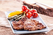 Grilled pork collar steak with a side of vegetables