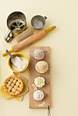 Flour, a rolling pin, a sieve and a tartlet