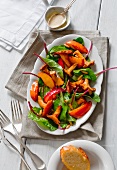 A salad made with roasted peaches, chard and chanterelle mushrooms