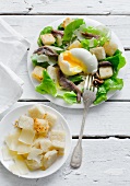 Caesar salad with sardines and egg