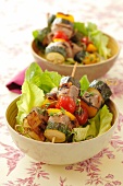 Pork and vegetable kebabs on lettuce