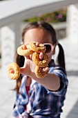 A little girl with mini sweet bread rings
